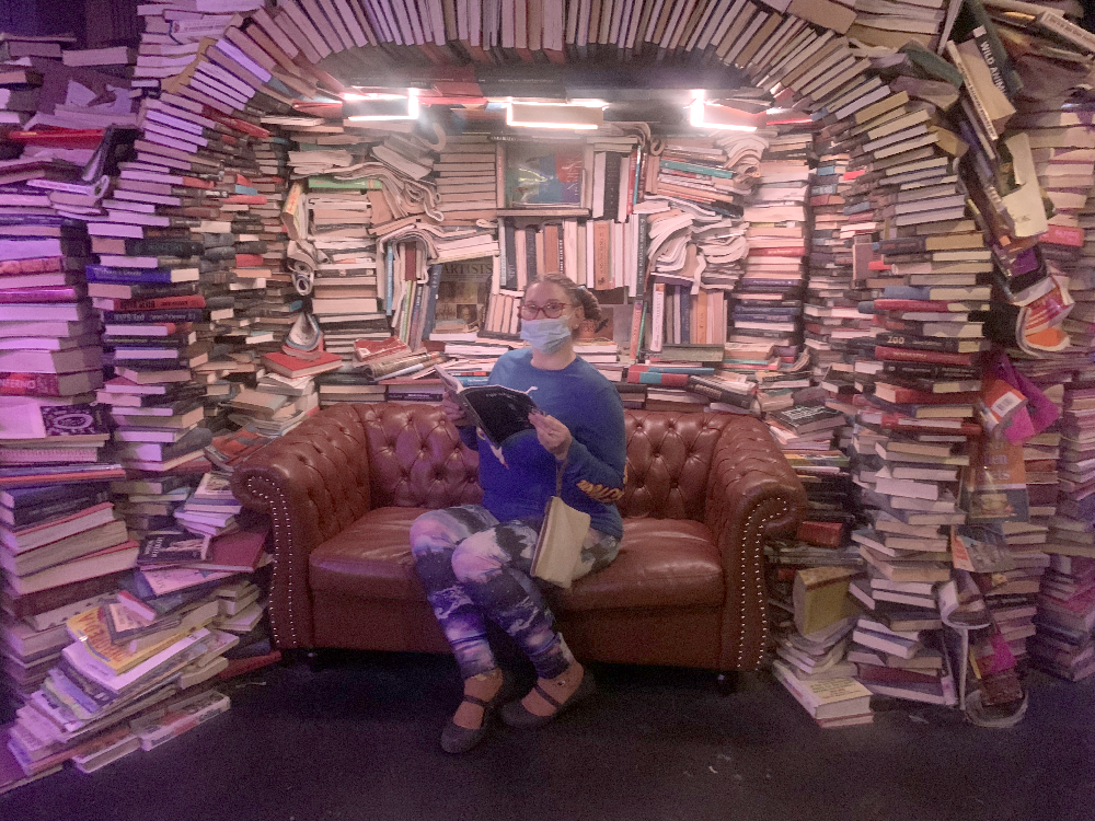 Anastasia Valentine Meow Wolf book cave smiling happy